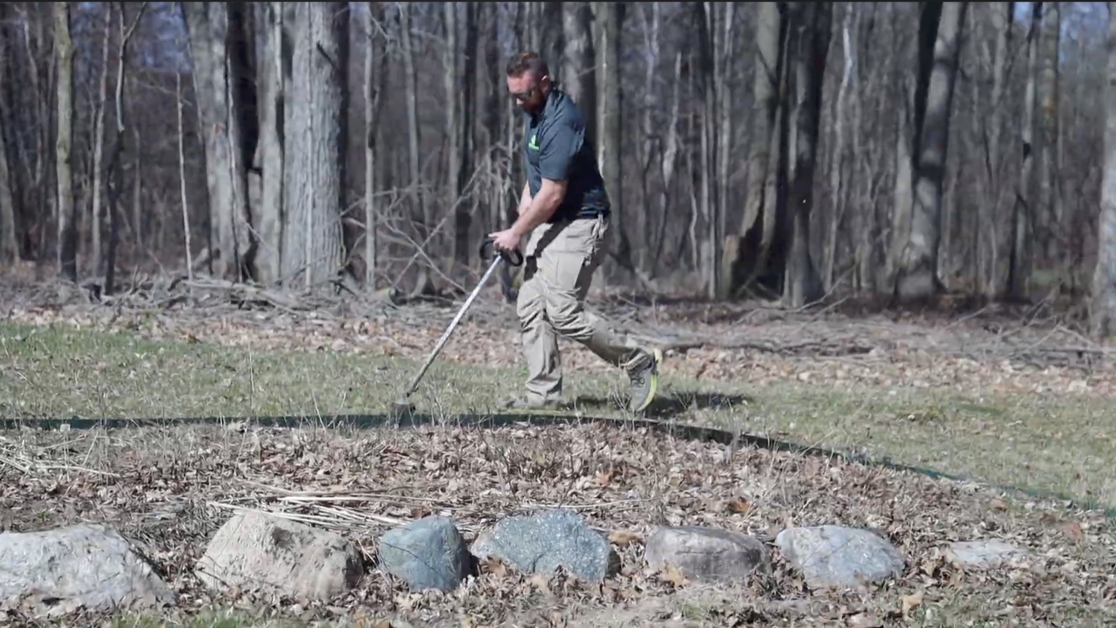 CrossCountry crew member trimming during a fall cleanup